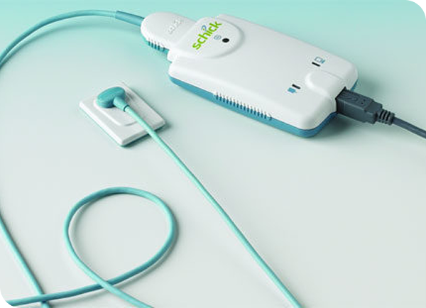 Portable medical device with connected sensor pad and USB cable, designed for patient monitoring and diagnostics.